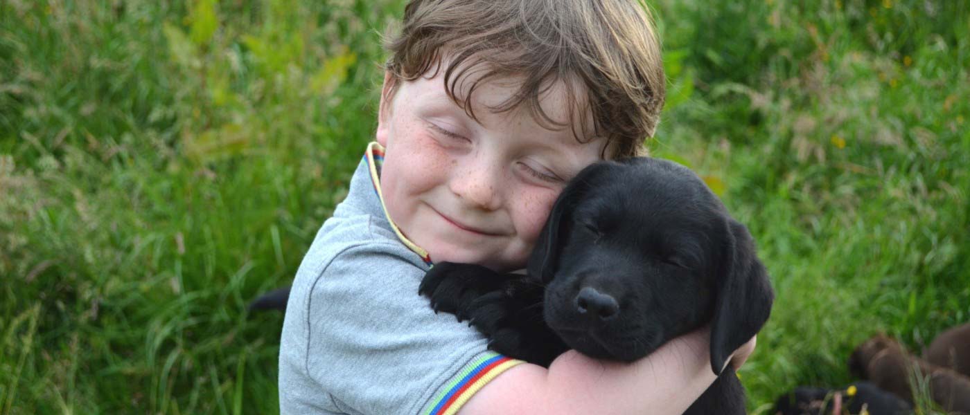 kiddo hugging a dog